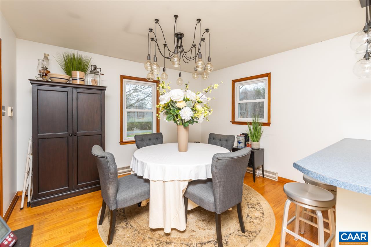 2564 Stagebridge Road Lovingston, VA 22949 - Photo 17 of 47 a dining room with furniture and chandelier