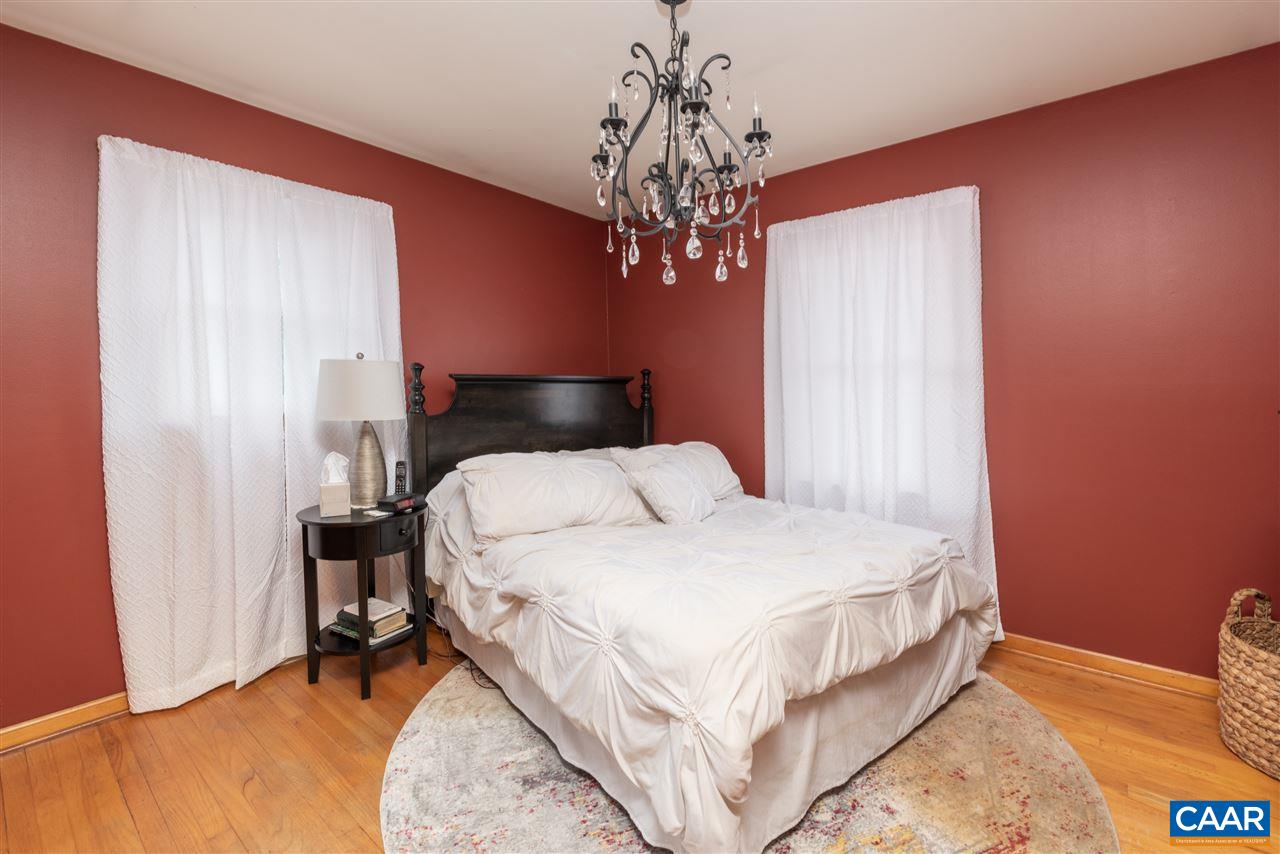2564 Stagebridge Road Lovingston, VA 22949 - Photo 22 of 47 a bedroom with a bed and a chandelier