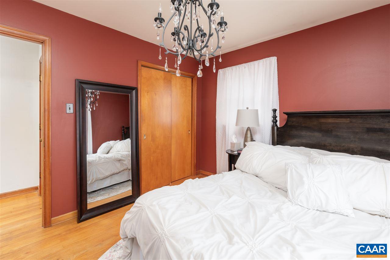 2564 Stagebridge Road Lovingston, VA 22949 - Photo 23 of 47 a bedroom with a large bed and a chandelier