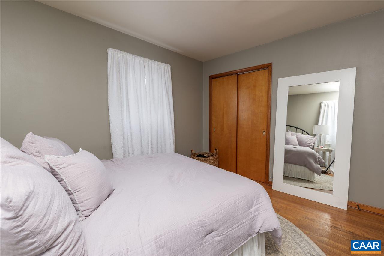 2564 Stagebridge Road Lovingston, VA 22949 - Photo 27 of 47 a bedroom with a bed and wooden floor