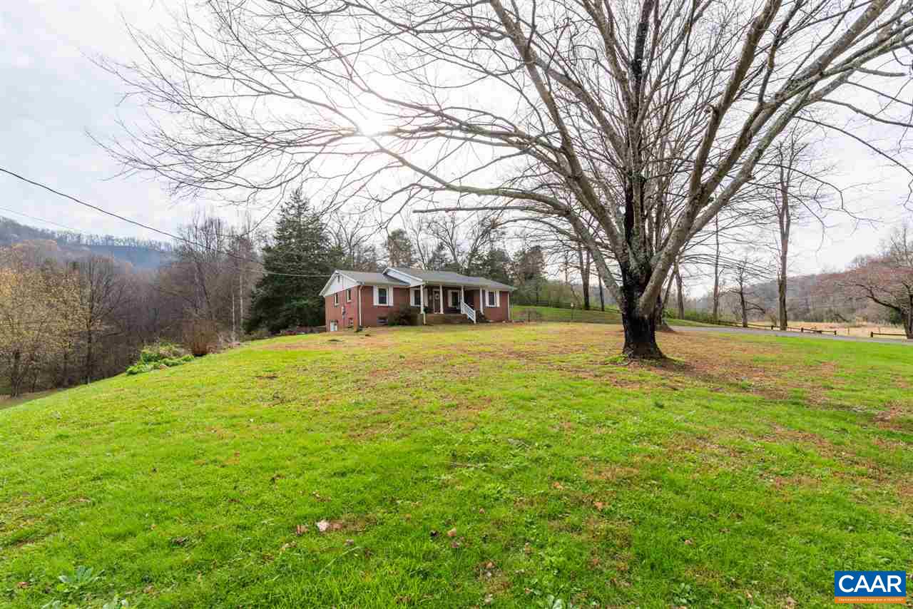 2564 Stagebridge Road Lovingston, VA 22949 - Photo 45 of 47 a yellow house with trees in front of it