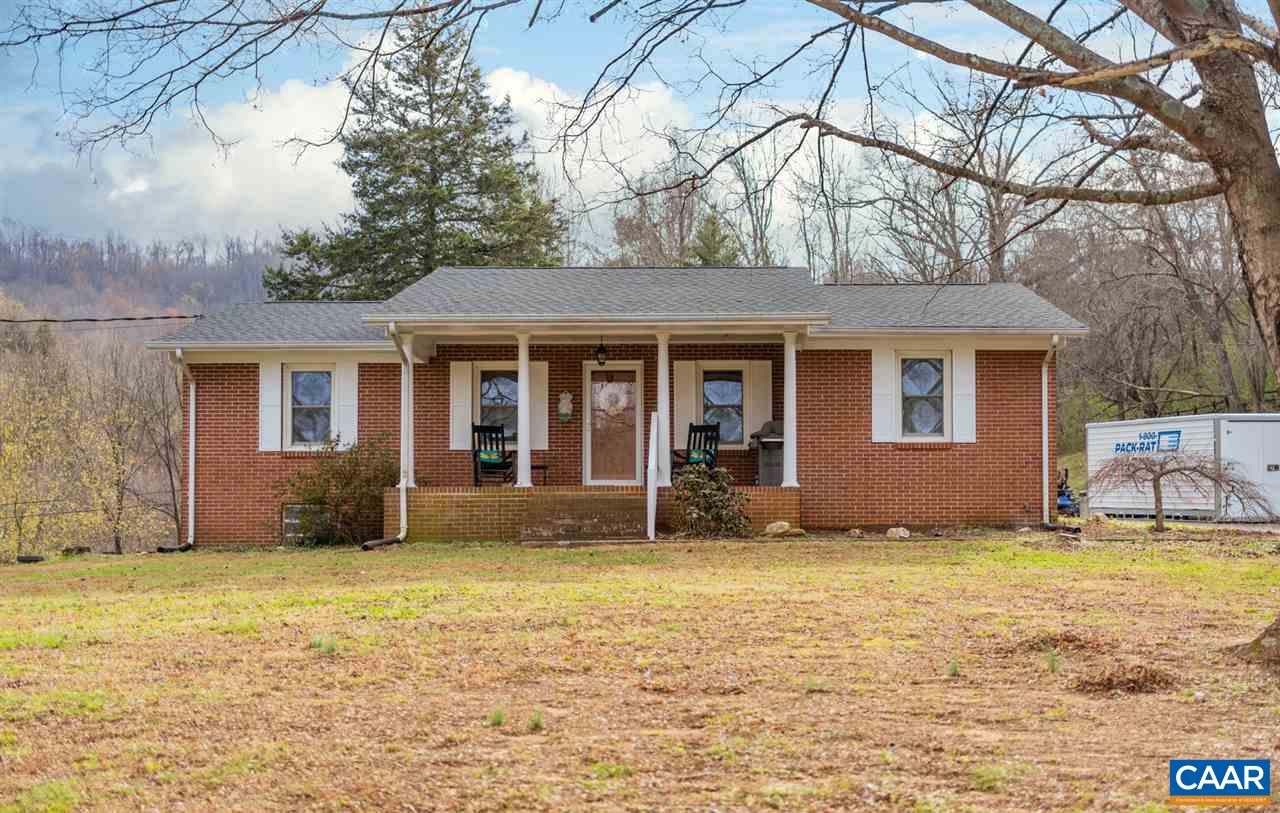 2564 Stagebridge Road Lovingston, VA 22949 - Photo 5 of 47 a front view of house with yard and trees in the background