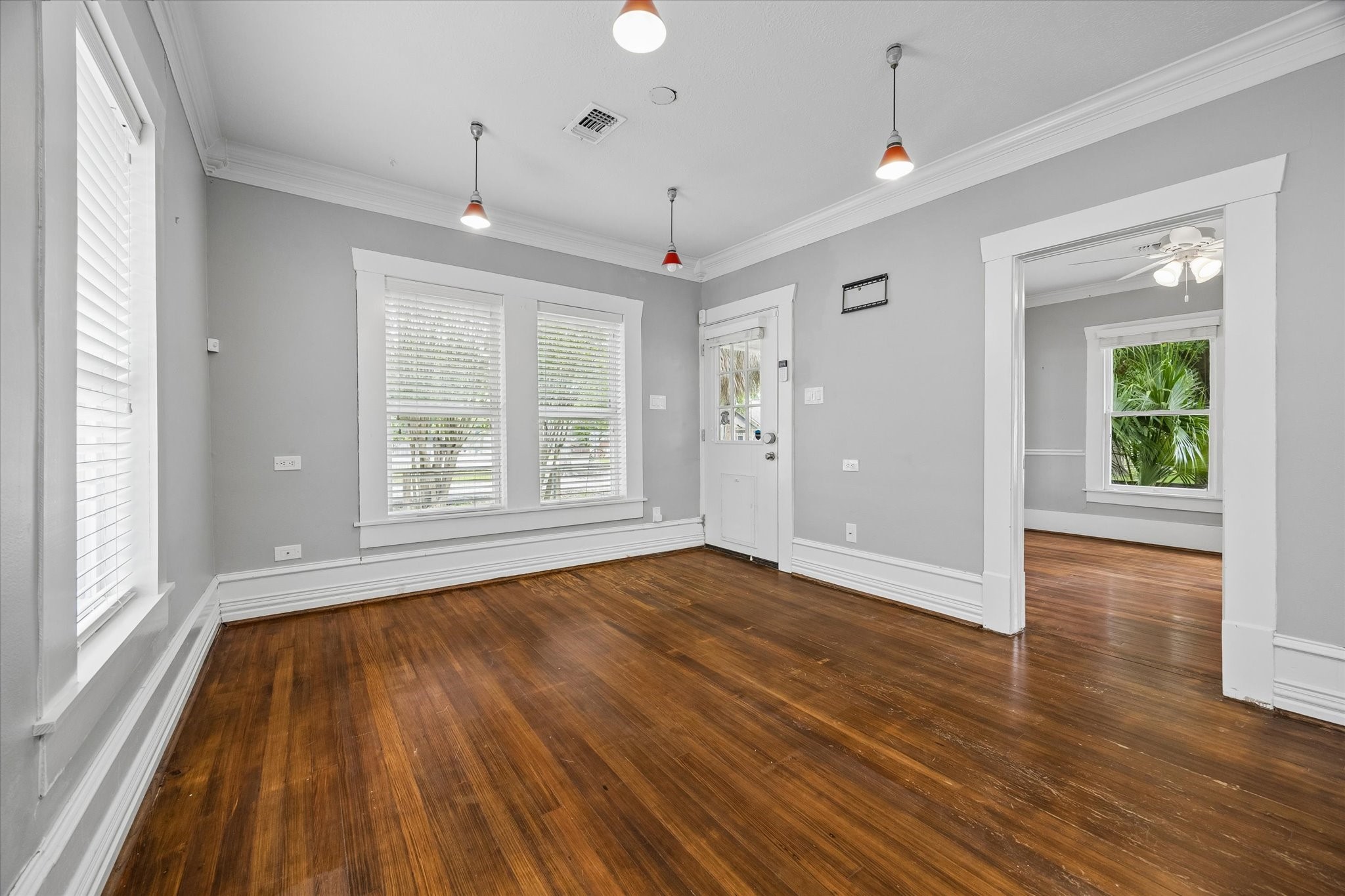 1201 Tulane Street Houston, TX 77008 - Photo 12 of 31 The expansive open living and dining area gives you the kind of flexible space that makes everyday living and entertaining feel easy, all wrapped in the Historic Heights charm you’ll love. Warm hardwood floors, thick baseboards, crown molding, oversized windows, updated lighting, and beautifully framed doorways bring classic 1930s Craftsman character into every corner.