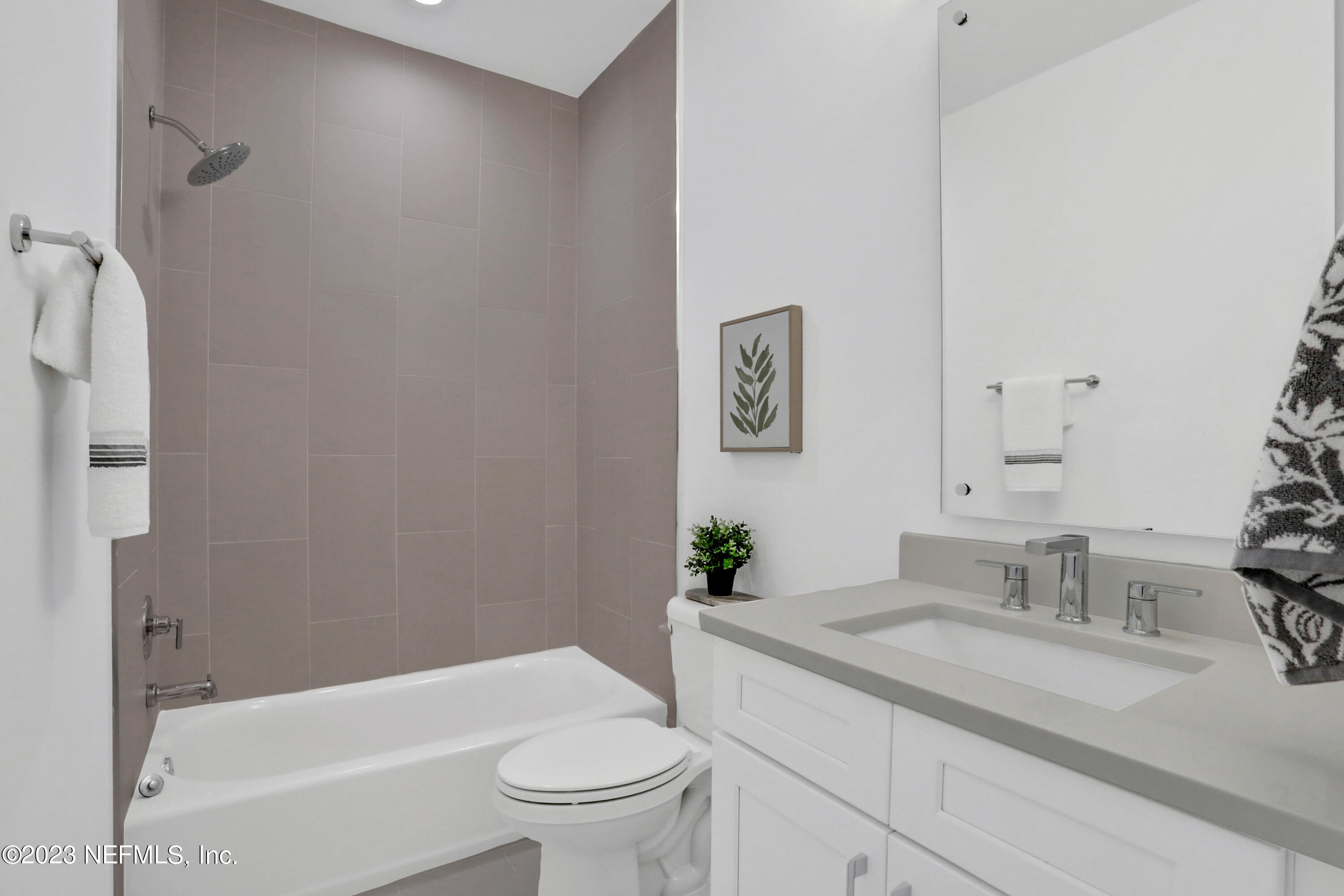 2107 Gordon Avenue Jacksonville Beach, FL 32250 - Photo 12 of 36 a bathroom with a granite countertop sink a toilet and bathtub