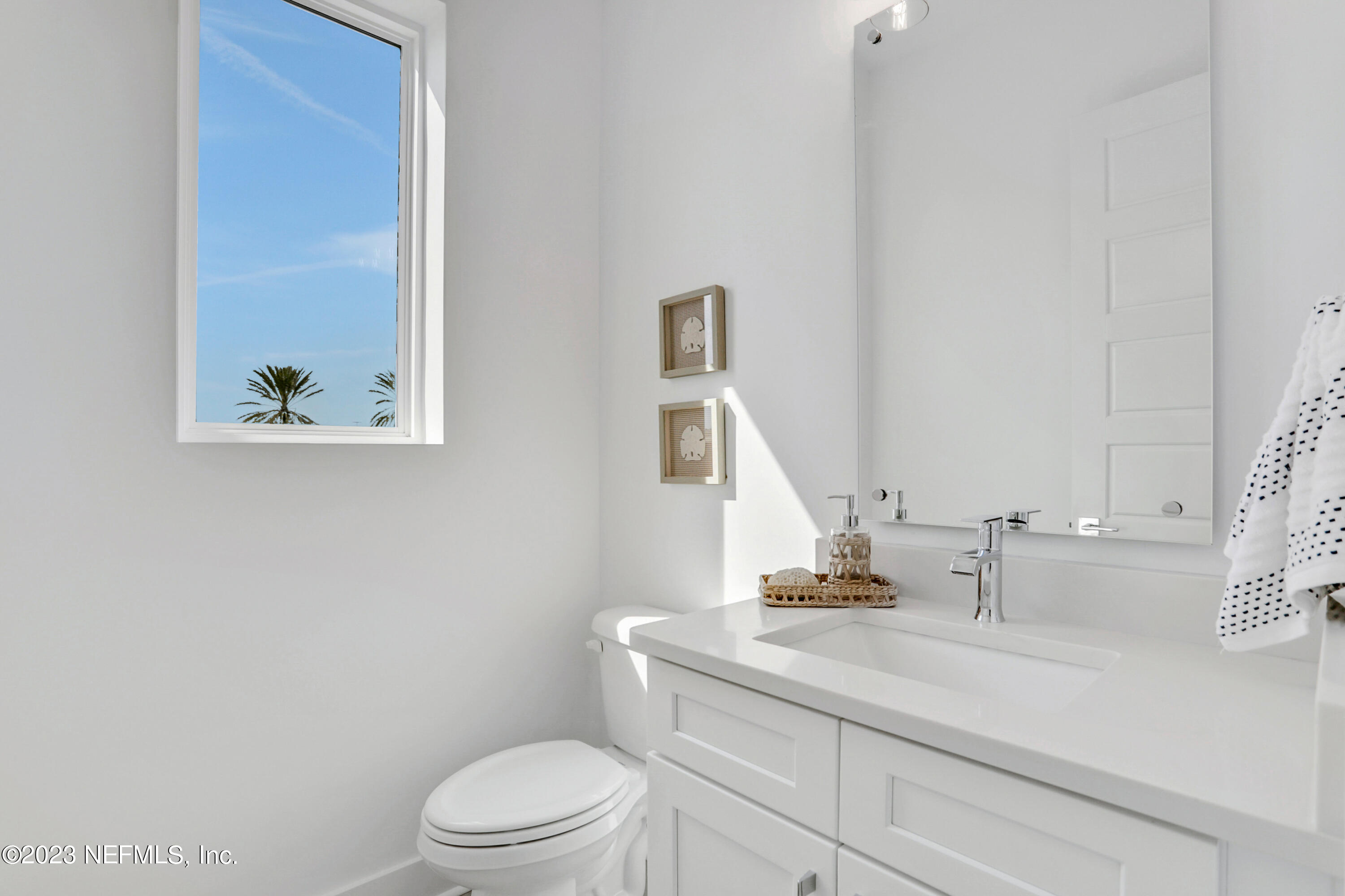 2107 Gordon Avenue Jacksonville Beach, FL 32250 - Photo 19 of 36 a bathroom with a sink a toilet and mirror