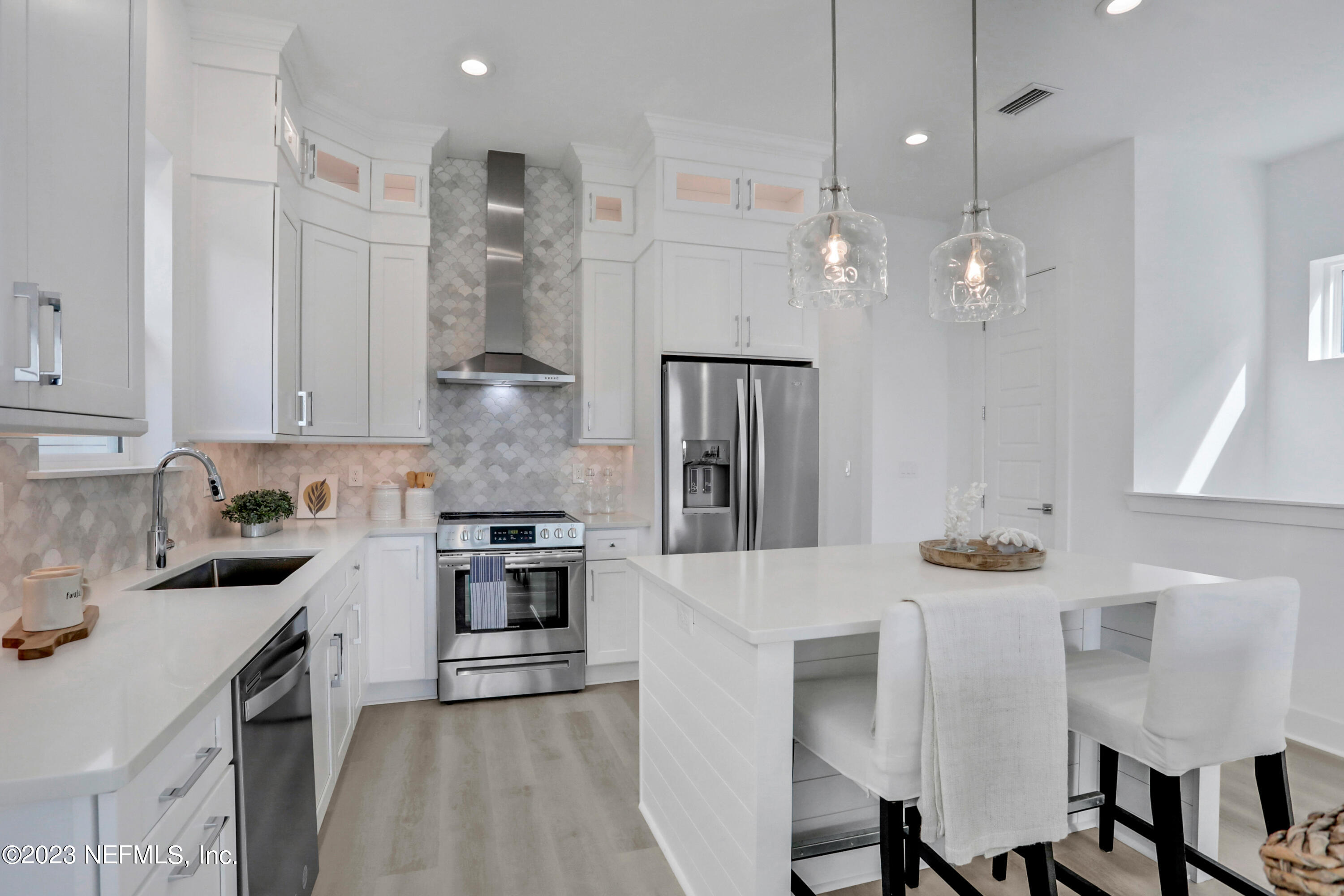 2107 Gordon Avenue Jacksonville Beach, FL 32250 - Photo 23 of 36 a kitchen with stainless steel appliances kitchen island granite countertop a stove a sink and a refrigerator