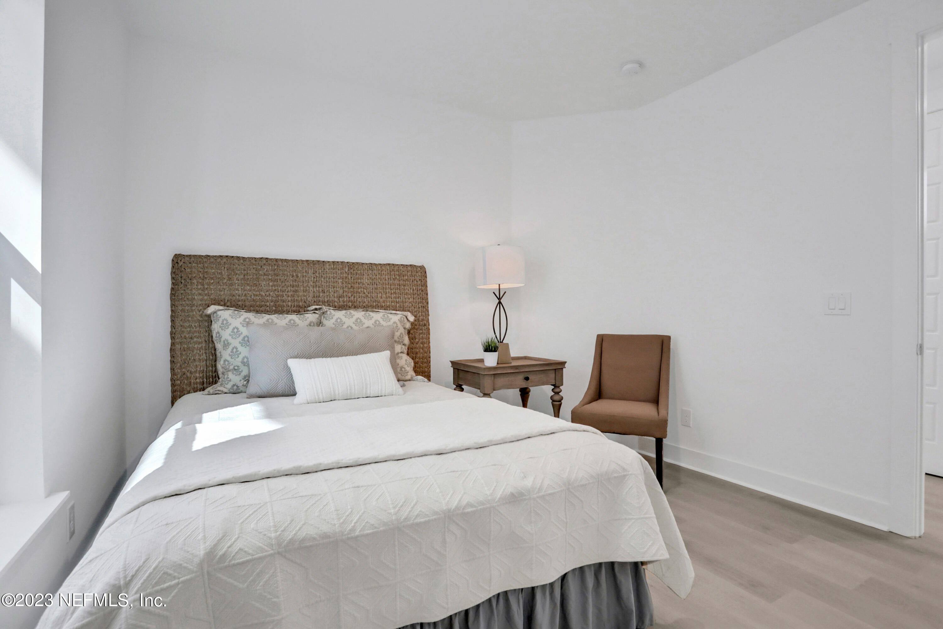 2107 Gordon Avenue Jacksonville Beach, FL 32250 - Photo 7 of 36 a large bed sitting in a bedroom next to a lamp