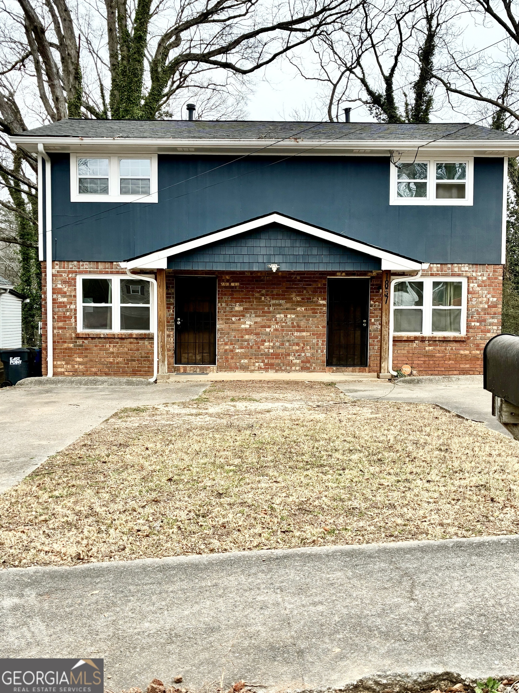 1859 Williams Avenue East Point, GA 30344 - Photo 19 of 20 a front view of a house with a yard and trees