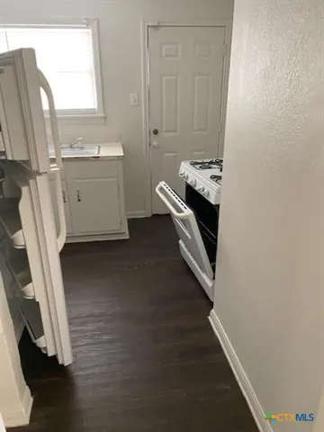 a bathroom with a sink a toilet and a window