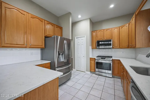 an aerial view of a house with a swimming pool and outdoor seating