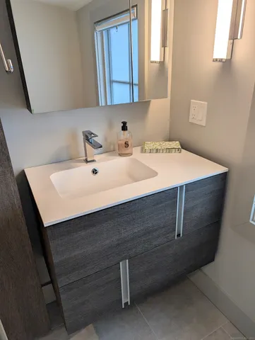 a white toilet sitting next to a white sink