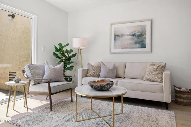 a living room with furniture and a potted plant