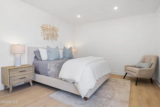 a bedroom with a bed and a chair