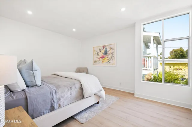 a bedroom with a large bed and a window