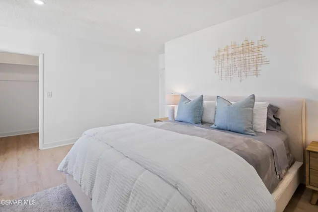 a bedroom with a bed and a night stand