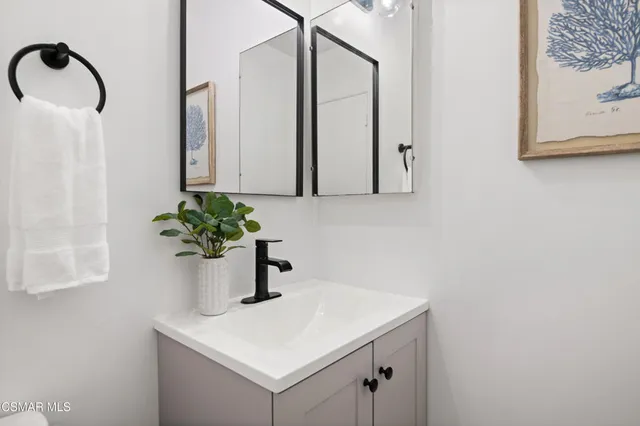 a bathroom with a sink a vanity and a mirror