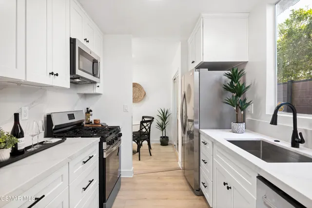 a kitchen with a sink stove and refrigerator