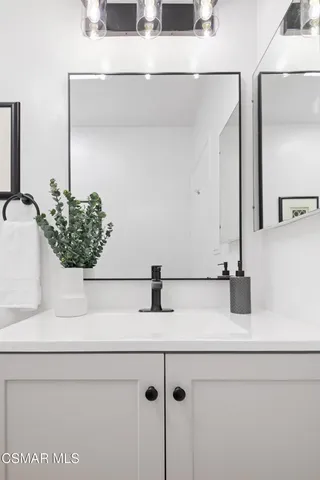 a bathroom with a sink and mirror