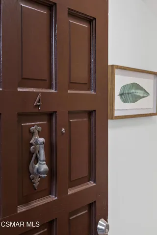 a house with a potted plant on the front of it
