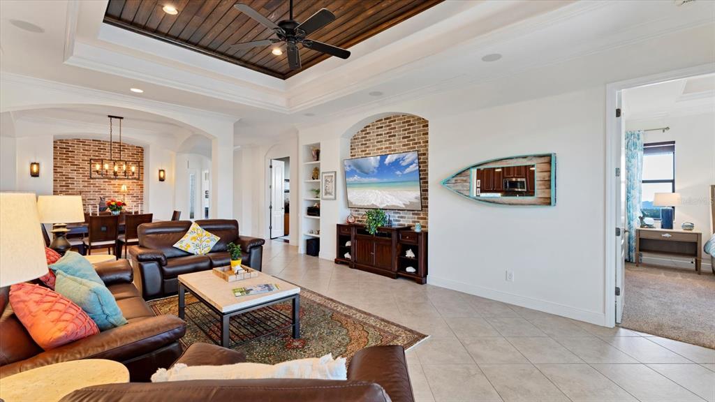 7833 Valderrama Way Lakewood Ranch, FL 34202 - Photo 11 of 63 a living room with fireplace furniture and a flat screen tv