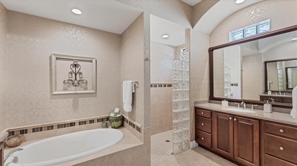 7833 Valderrama Way Lakewood Ranch, FL 34202 - Photo 23 of 63 a bathroom with a tub a sink and mirror