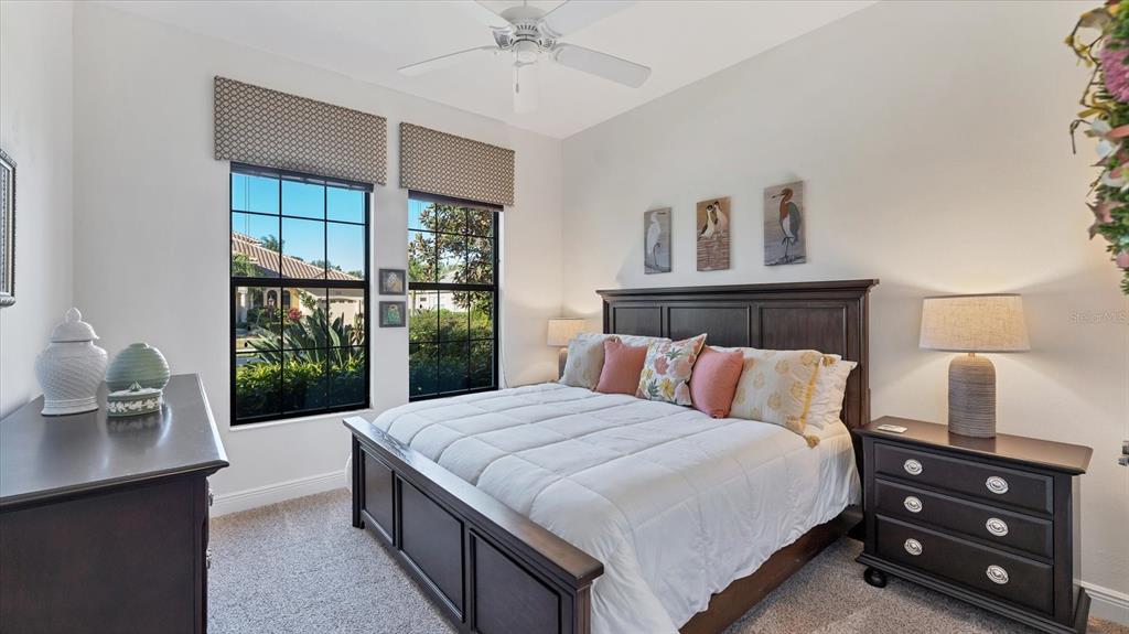 7833 Valderrama Way Lakewood Ranch, FL 34202 - Photo 26 of 63 a bedroom with a large bed and a window