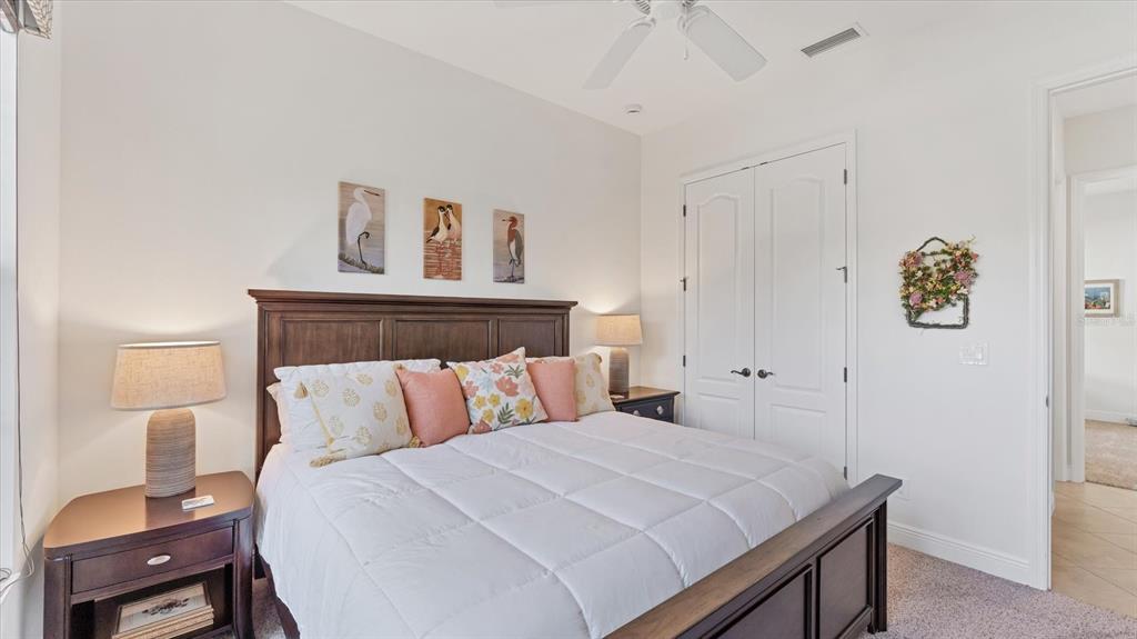 7833 Valderrama Way Lakewood Ranch, FL 34202 - Photo 27 of 63 a bedroom with a bed and painting on the wall