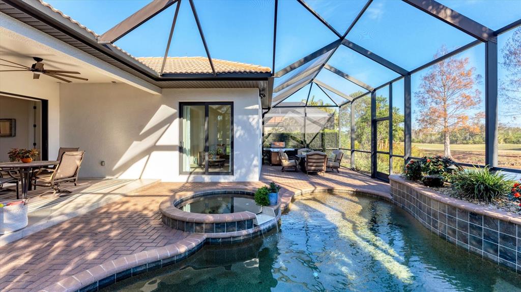 7833 Valderrama Way Lakewood Ranch, FL 34202 - Photo 38 of 63 a swimming pool with outdoor seating and yard