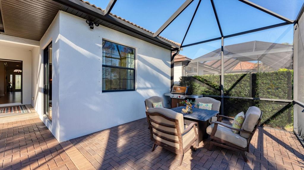 7833 Valderrama Way Lakewood Ranch, FL 34202 - Photo 39 of 63 a patio with glass top table and chairs