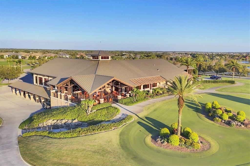 7833 Valderrama Way Lakewood Ranch, FL 34202 - Photo 55 of 63 a view of a swimming pool with a table and chairs