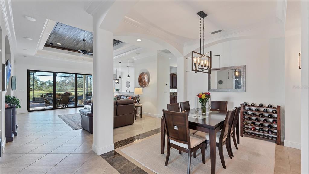 7833 Valderrama Way Lakewood Ranch, FL 34202 - Photo 7 of 63 a view of a dining room with furniture wooden floor and chandelier