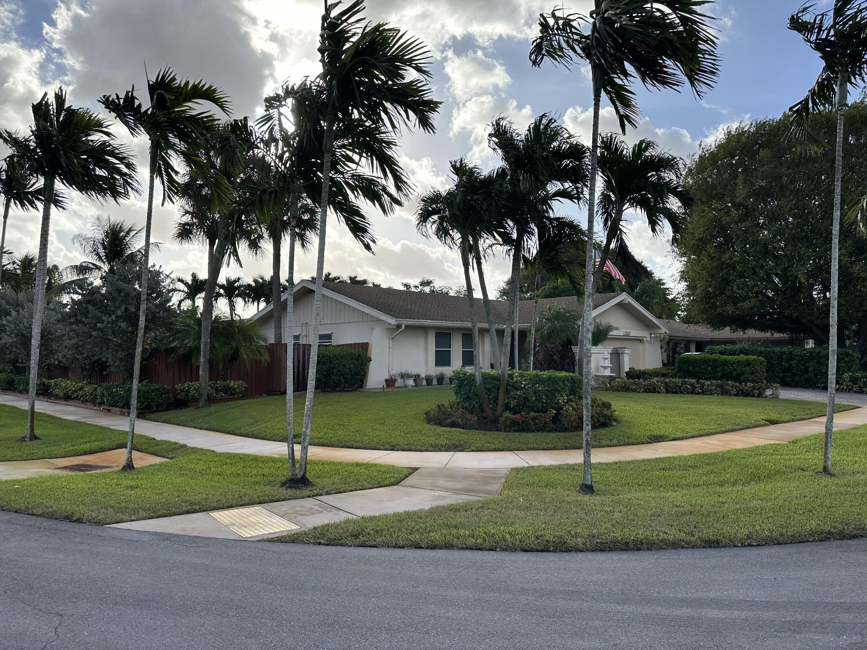17564 Weeping Willow Trail Boca Raton, FL 33487 - Photo 2 of 2 a view of a house with a yard and palm trees