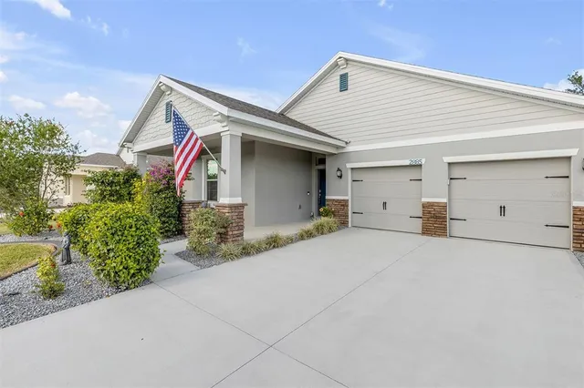 a living room with furniture ceiling fan and a flat screen tv