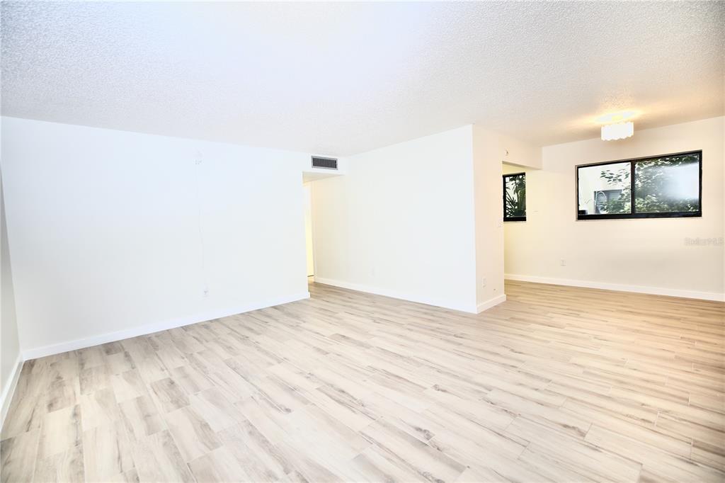11702 Raintree Village Boulevard, Unit B Temple Terrace, FL 33617 - Photo 11 of 38 a view of a room with wooden floor and wall painting