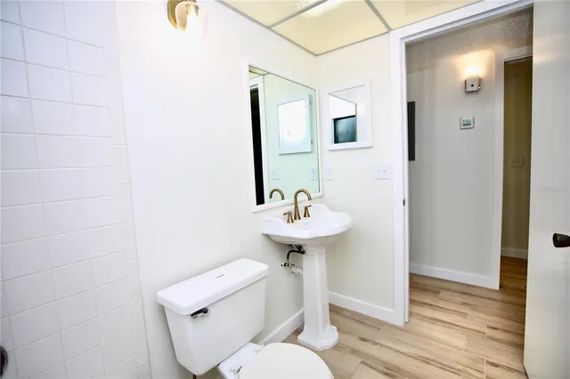 a bathroom with a sink toilet and a mirror