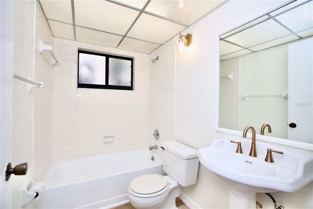 11702 Raintree Village Boulevard, Unit B Temple Terrace, FL 33617 - Photo 13 of 38 a bathroom with a sink toilet and shower