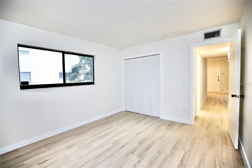 11702 Raintree Village Boulevard, Unit B Temple Terrace, FL 33617 - Photo 14 of 38 an empty room with wooden floor and windows