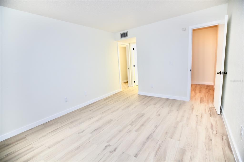 11702 Raintree Village Boulevard, Unit B Temple Terrace, FL 33617 - Photo 18 of 38 wooden floor in an empty room
