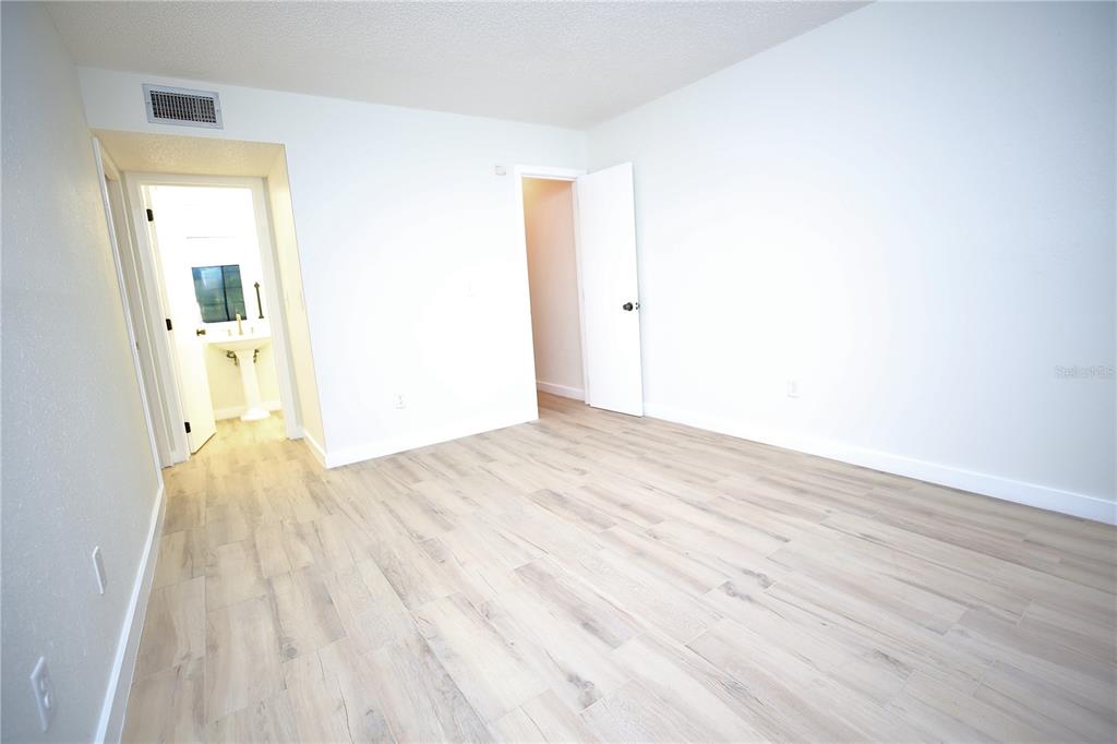 11702 Raintree Village Boulevard, Unit B Temple Terrace, FL 33617 - Photo 19 of 38 a view of a room with wooden floor and a bathroom