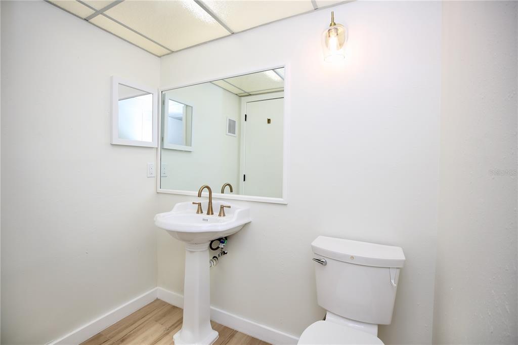 11702 Raintree Village Boulevard, Unit B Temple Terrace, FL 33617 - Photo 20 of 38 a bathroom with a sink toilet and a mirror