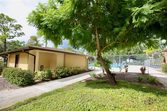 a view of backyard of house with green space