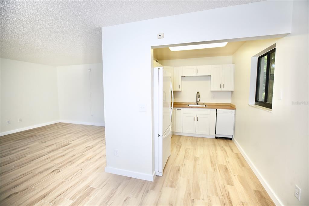 11702 Raintree Village Boulevard, Unit B Temple Terrace, FL 33617 - Photo 4 of 38 a view of a kitchen with wooden floor and a sink