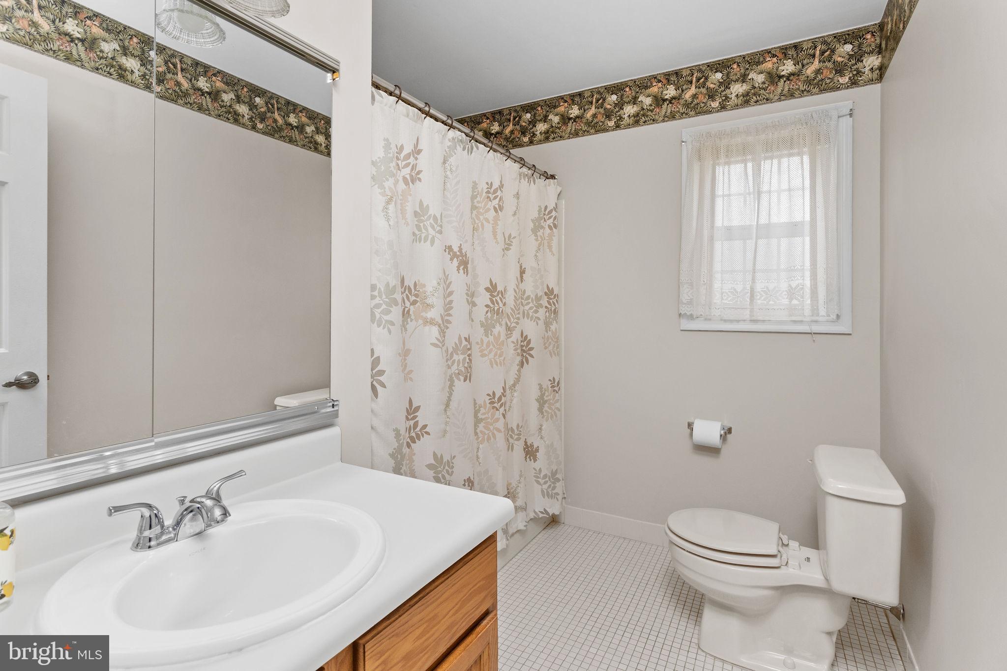 12 Candlelight Circle Columbus, NJ 08022 - Photo 16 of 17 a bathroom with a sink a toilet and shower curtain
