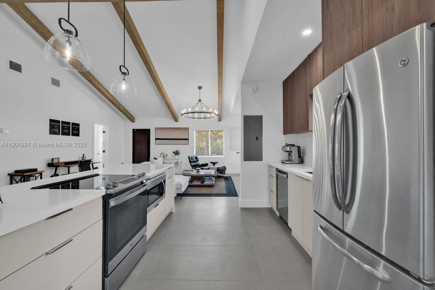 901 Northwest 7th Street Miami, FL 33136 - Photo 13 of 98 a large kitchen with stainless steel appliances a refrigerator a stove a sink dishwasher a oven with white cabinets and wooden floor