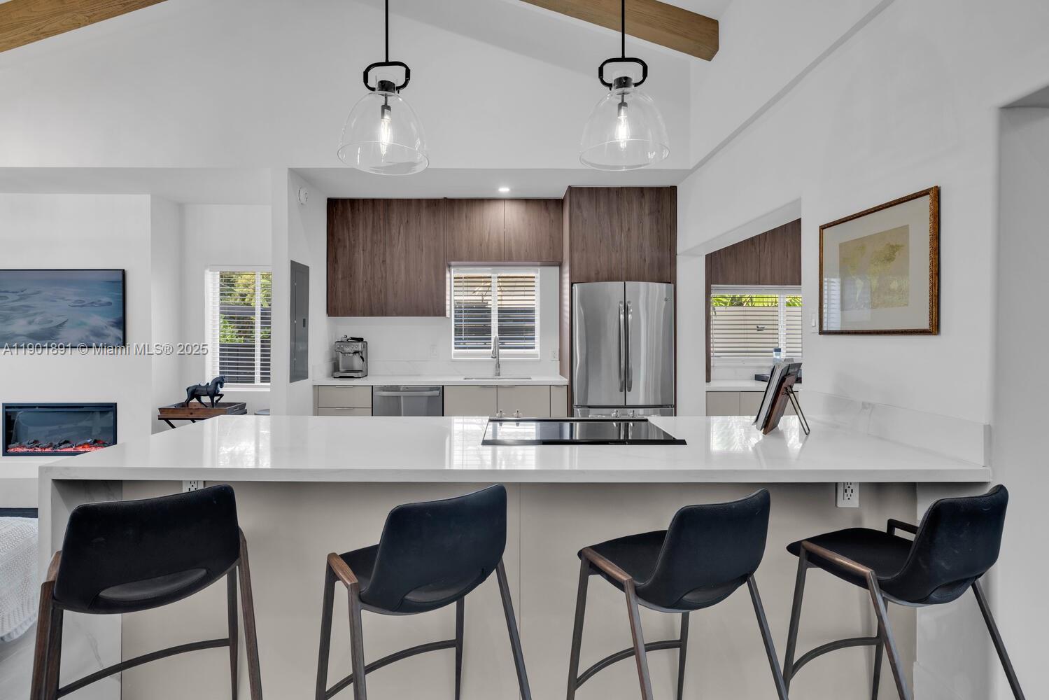 901 Northwest 7th Street Miami, FL 33136 - Photo 14 of 98 a kitchen with granite countertop white cabinets and chairs