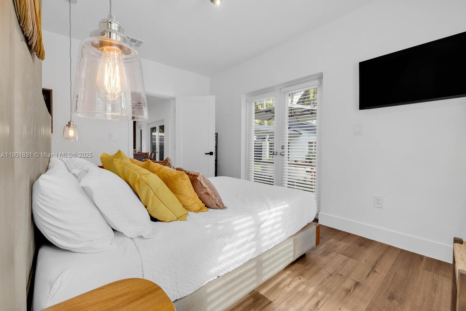 901 Northwest 7th Street Miami, FL 33136 - Photo 25 of 98 a bedroom with a bed and a flat screen tv