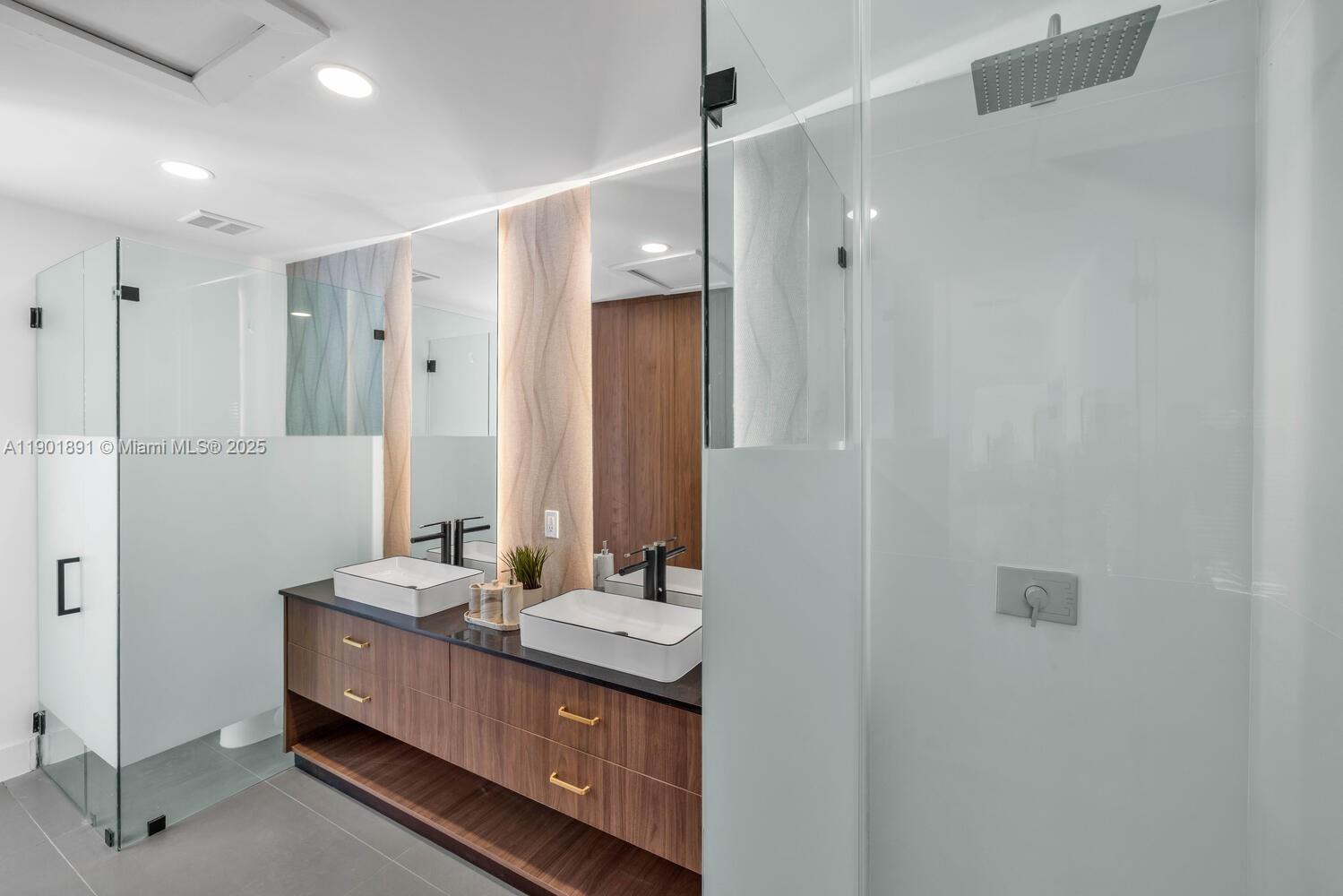 901 Northwest 7th Street Miami, FL 33136 - Photo 27 of 98 a bathroom with a double vanity sink and mirror