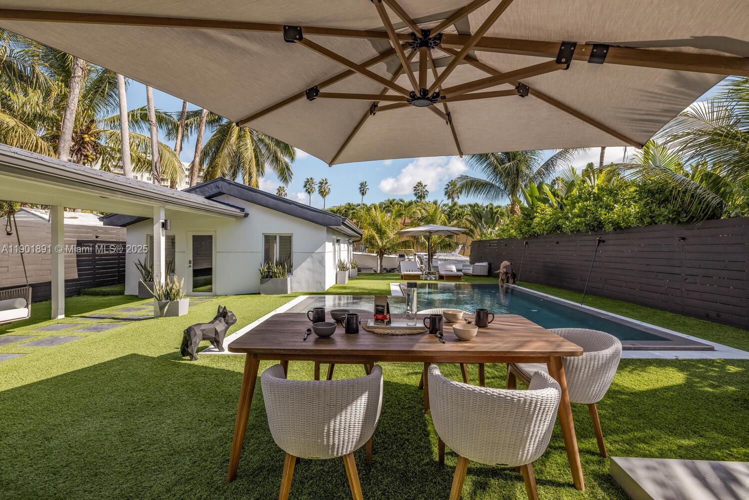 901 Northwest 7th Street Miami, FL 33136 - Photo 29 of 98 a patio with a table and chairs under an umbrella