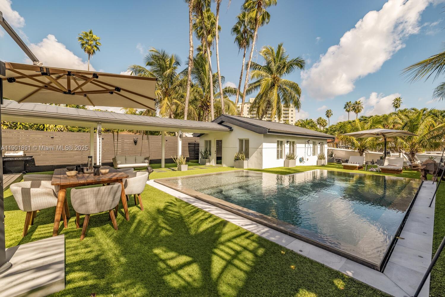 901 Northwest 7th Street Miami, FL 33136 - Photo 58 of 98 a view of a swimming pool with a lounge chairs