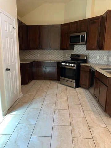 a kitchen with a cabinets and steel appliances